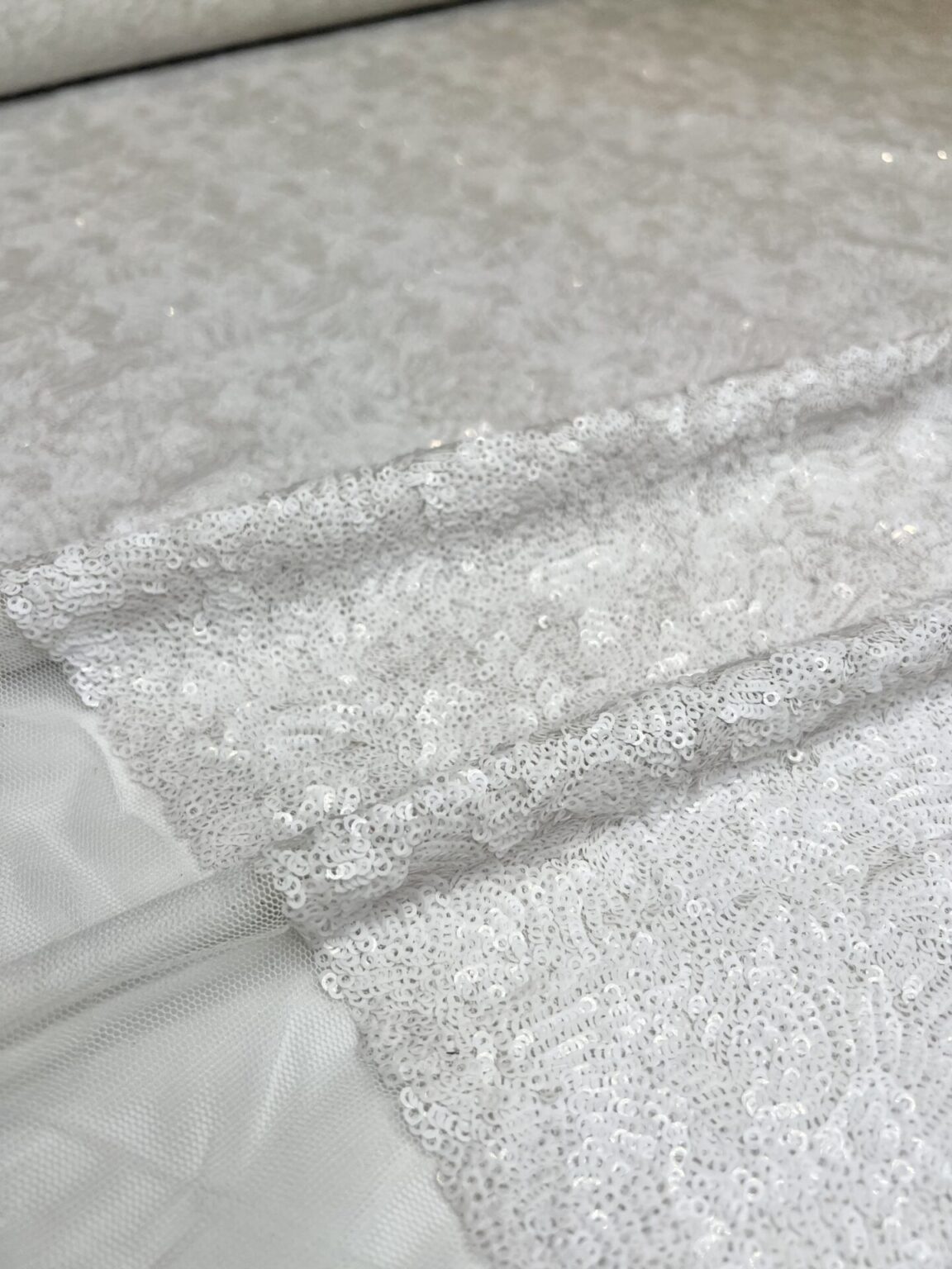 Fabric with sequins in white color