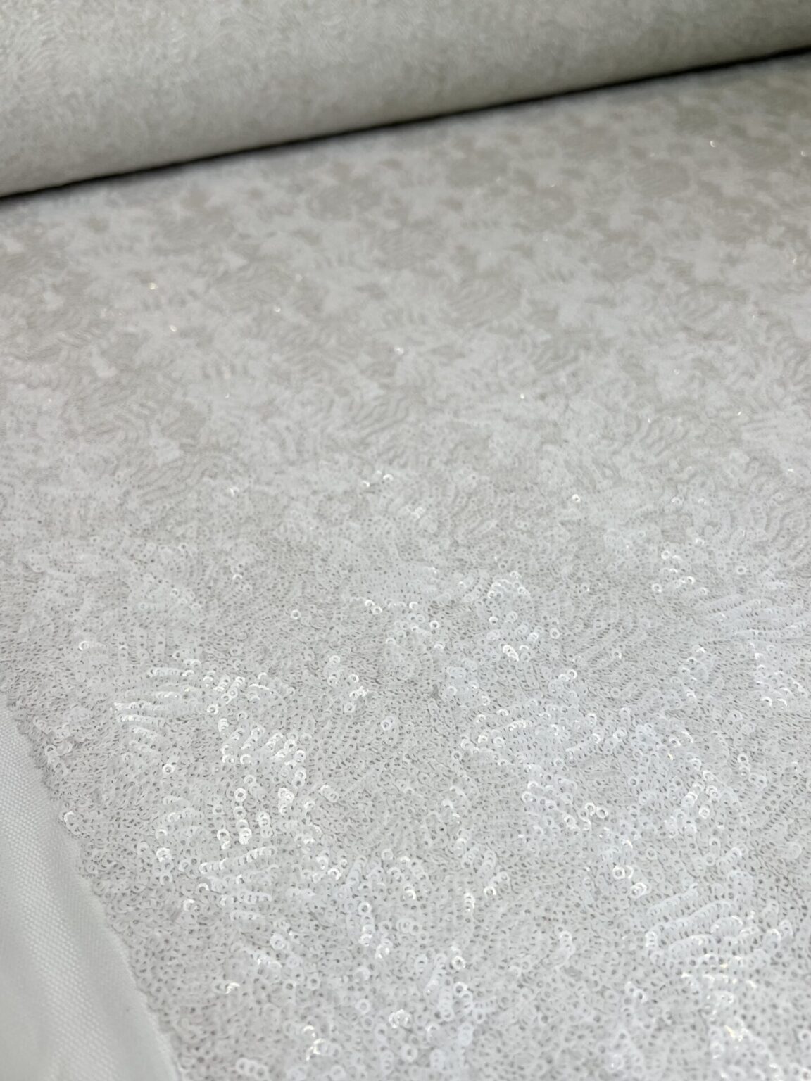 Fabric with sequins in white color