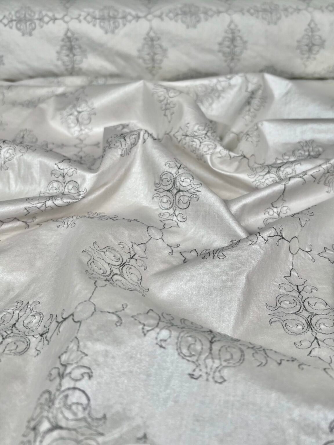 Shiny embroidered cotton in silver gray color