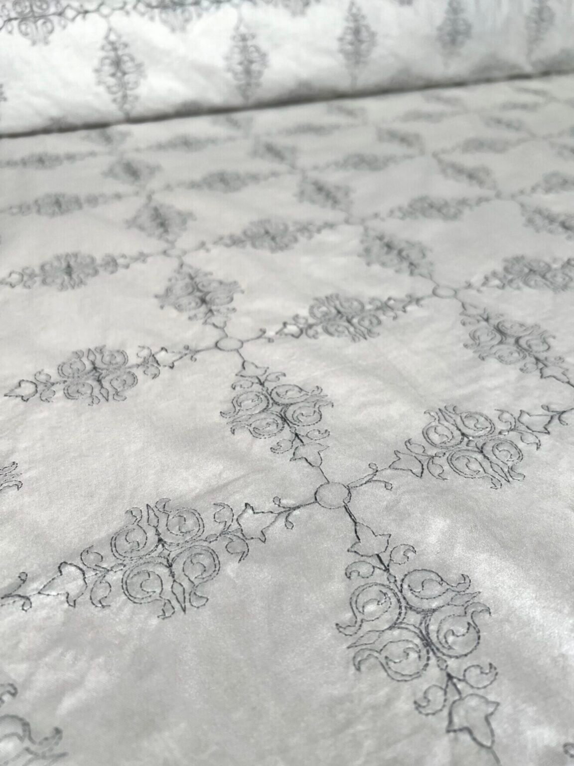 Shiny embroidered cotton in silver gray color