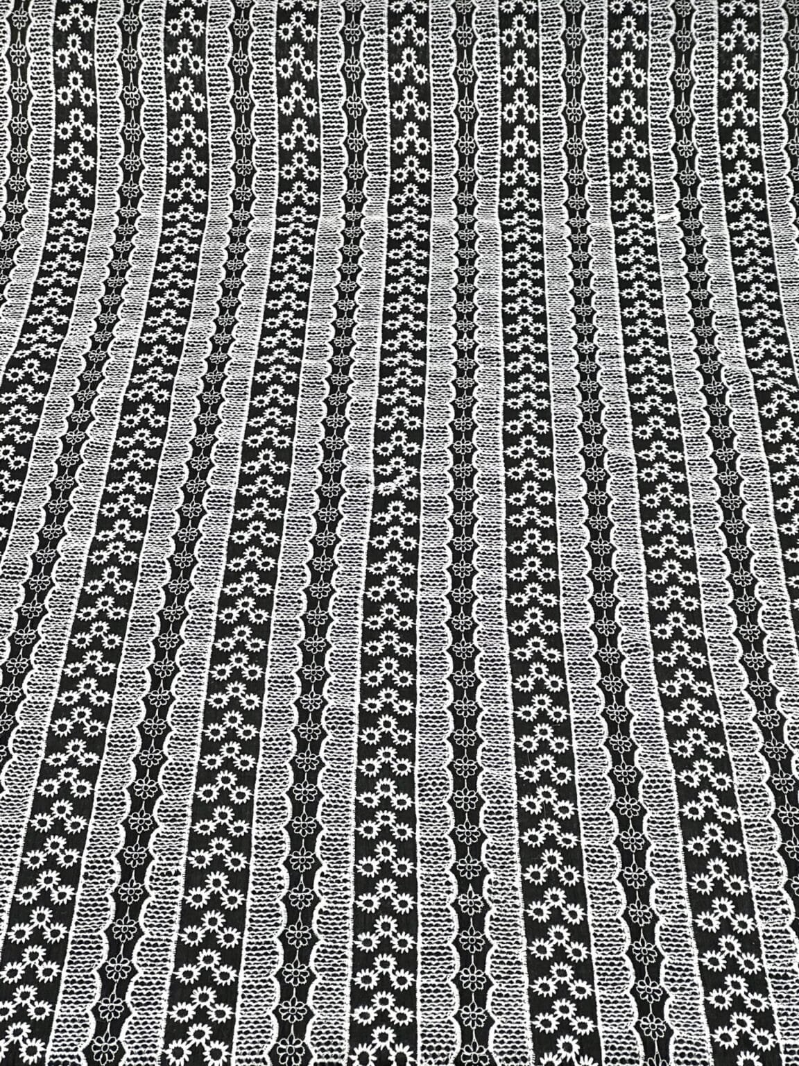 Embroidered cotton fabric in black with white patterns
