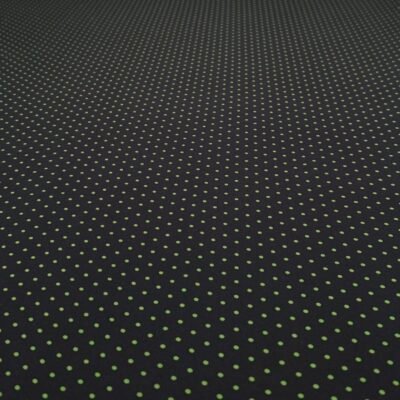 Dark fabric with a repeating pattern of small lime-green dots