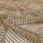 Close-up of gold sequin mesh fabric with tiny reflective beads in a grid pattern